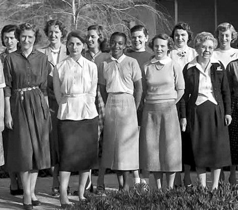 Black and white photo of two rows of women standing for a group photo. They appear to be all white women except one in the center, who is Black (Janez Lawson).